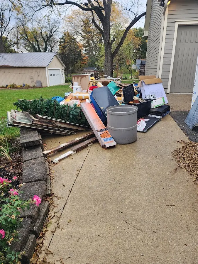 Dumpster being loaded with debris for Estate Cleanout Dumpster Rental in Chickasha